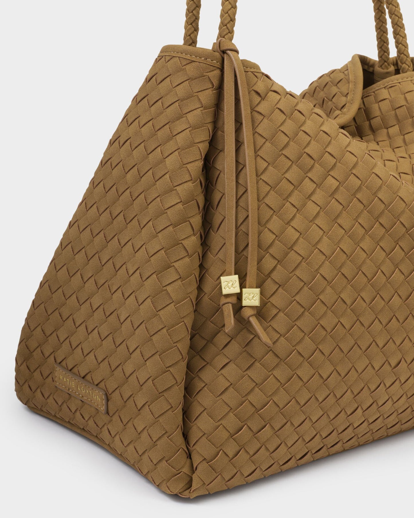 Brown woven handbag with drawstring on a light gray background