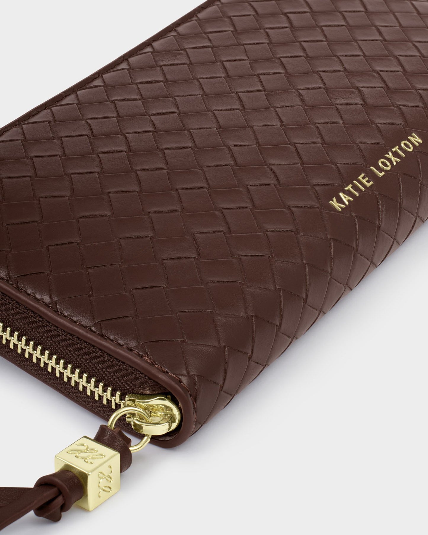 Brown woven wallet with gold zipper and 'Katie Loxton' branding on a white background