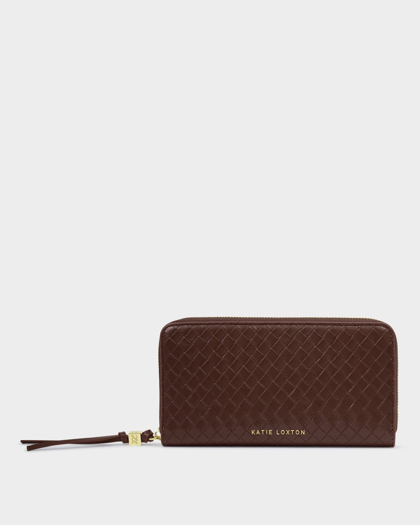 Brown quilted wallet with a strap on a light gray background
