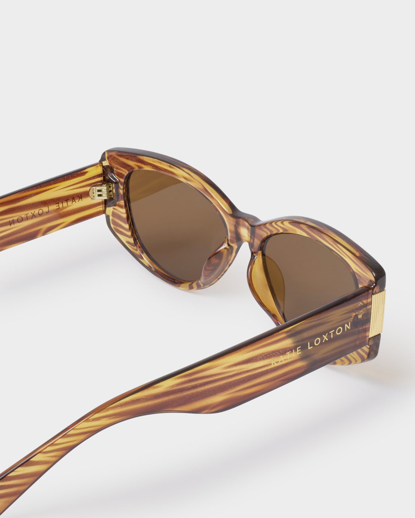 Katie Loxton | Rimini Cat-Eye Sunglasses | Striped Brown Transparent
