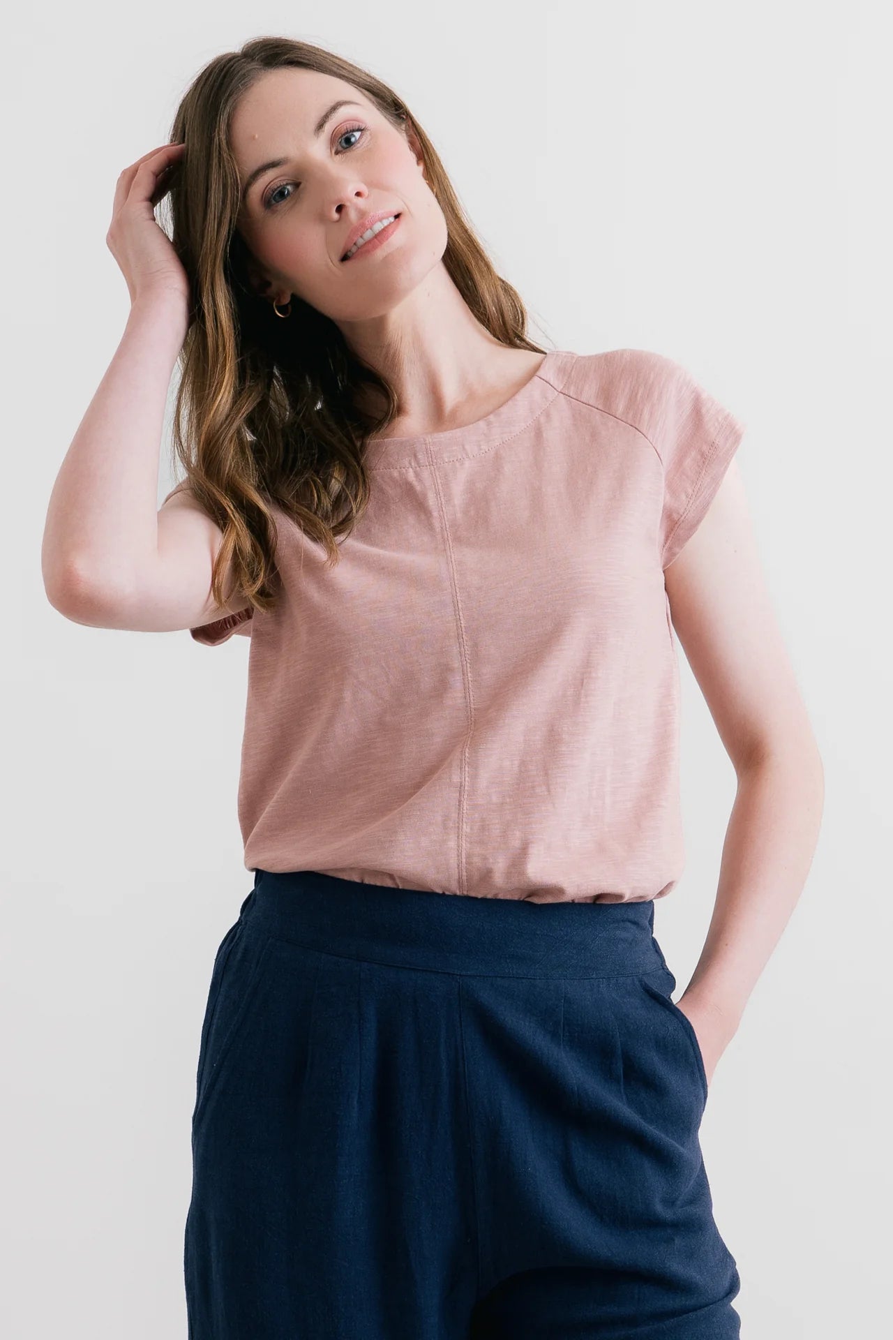 Model wearing pink t-shirt and navy trousers