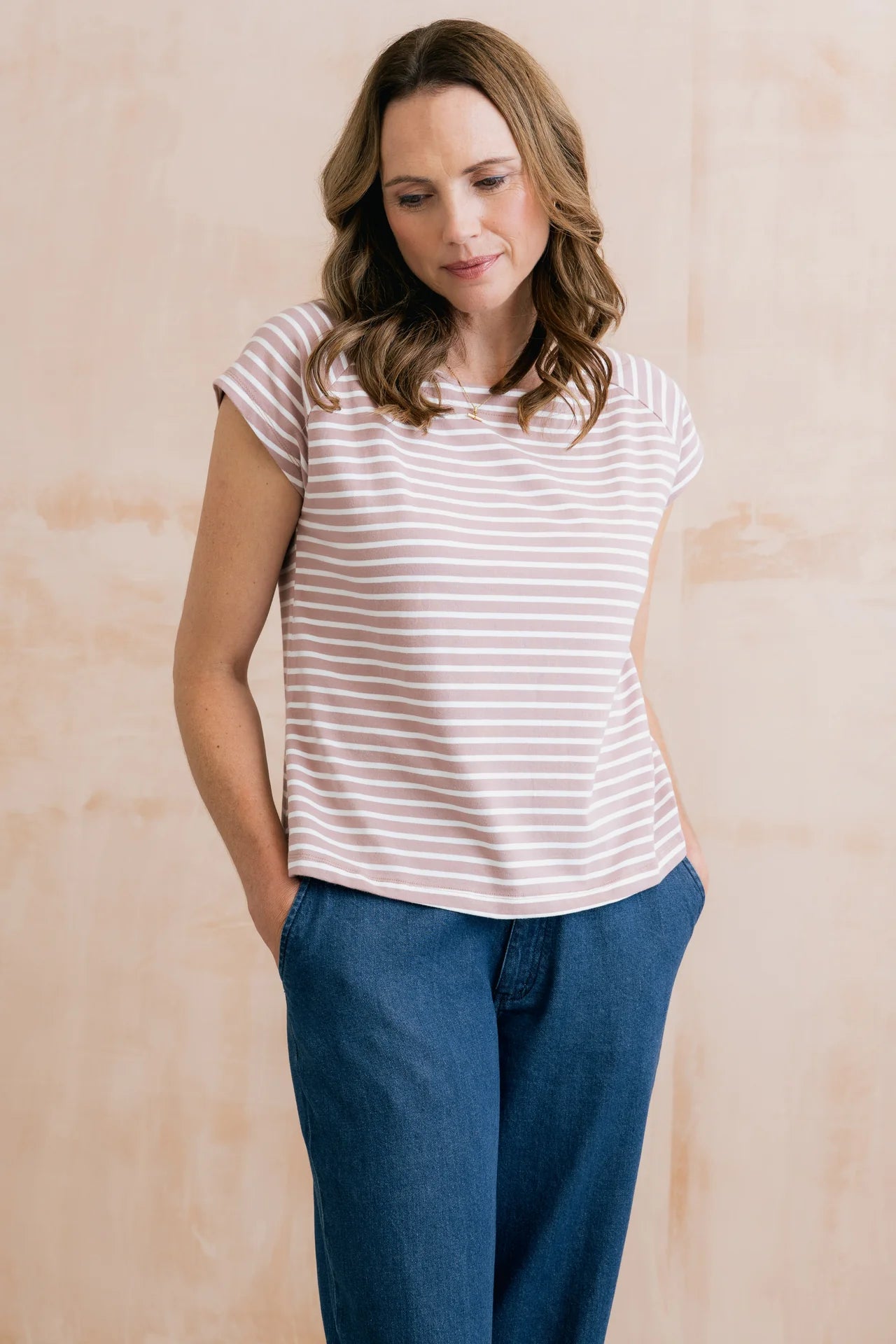 Model wearing pink and white striped tee with jeans