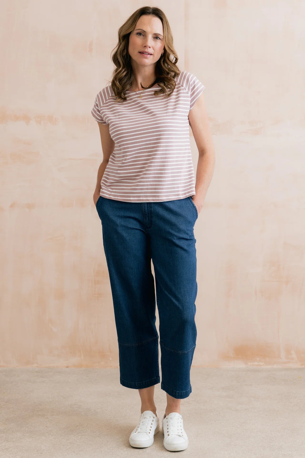 Model wearing a striped tee with jeans and white pumps