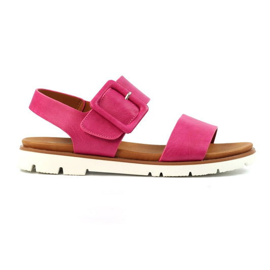 Pink sandal with a brown sole on a white background