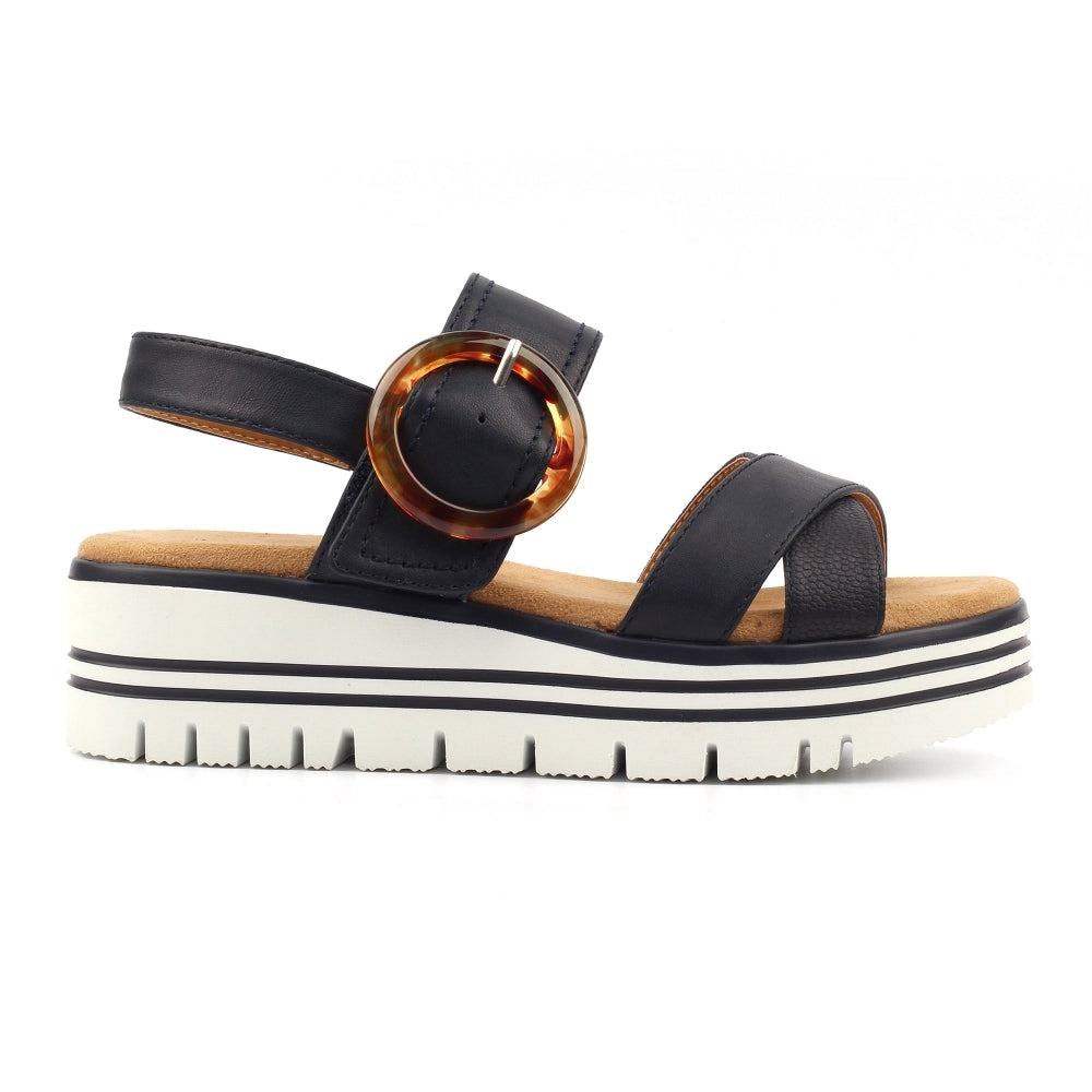 Navy sandal with a tortoiseshell buckle on a white background