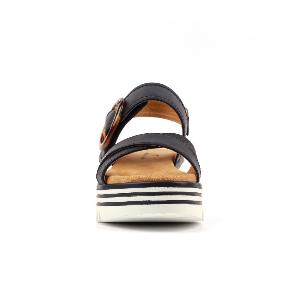Navy sandal with a white sole on a white background