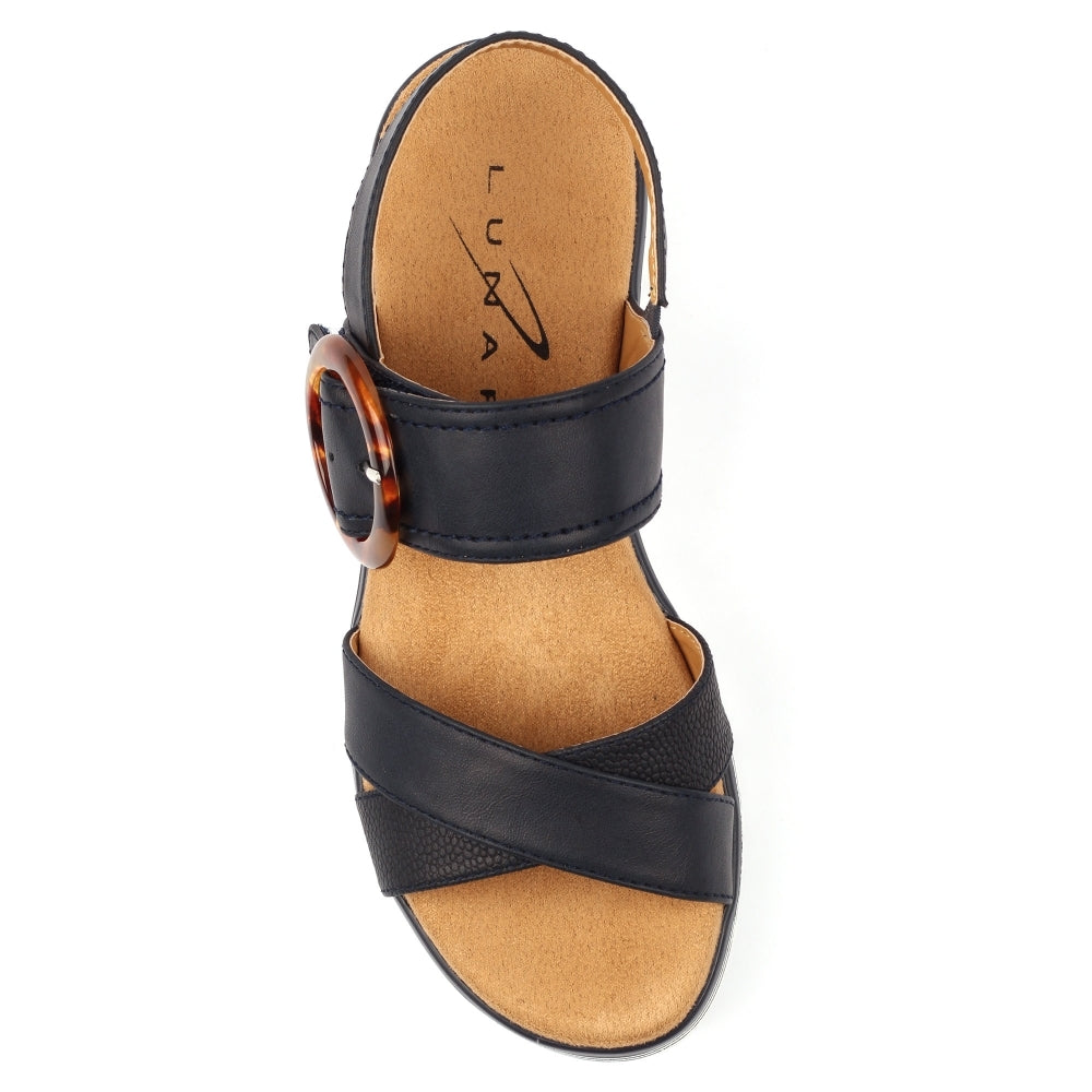 Navy sandal with a tortoiseshell buckle on a white background