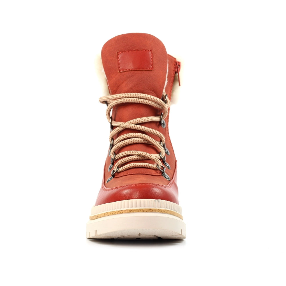 Orange winter boot with white sole on a white background