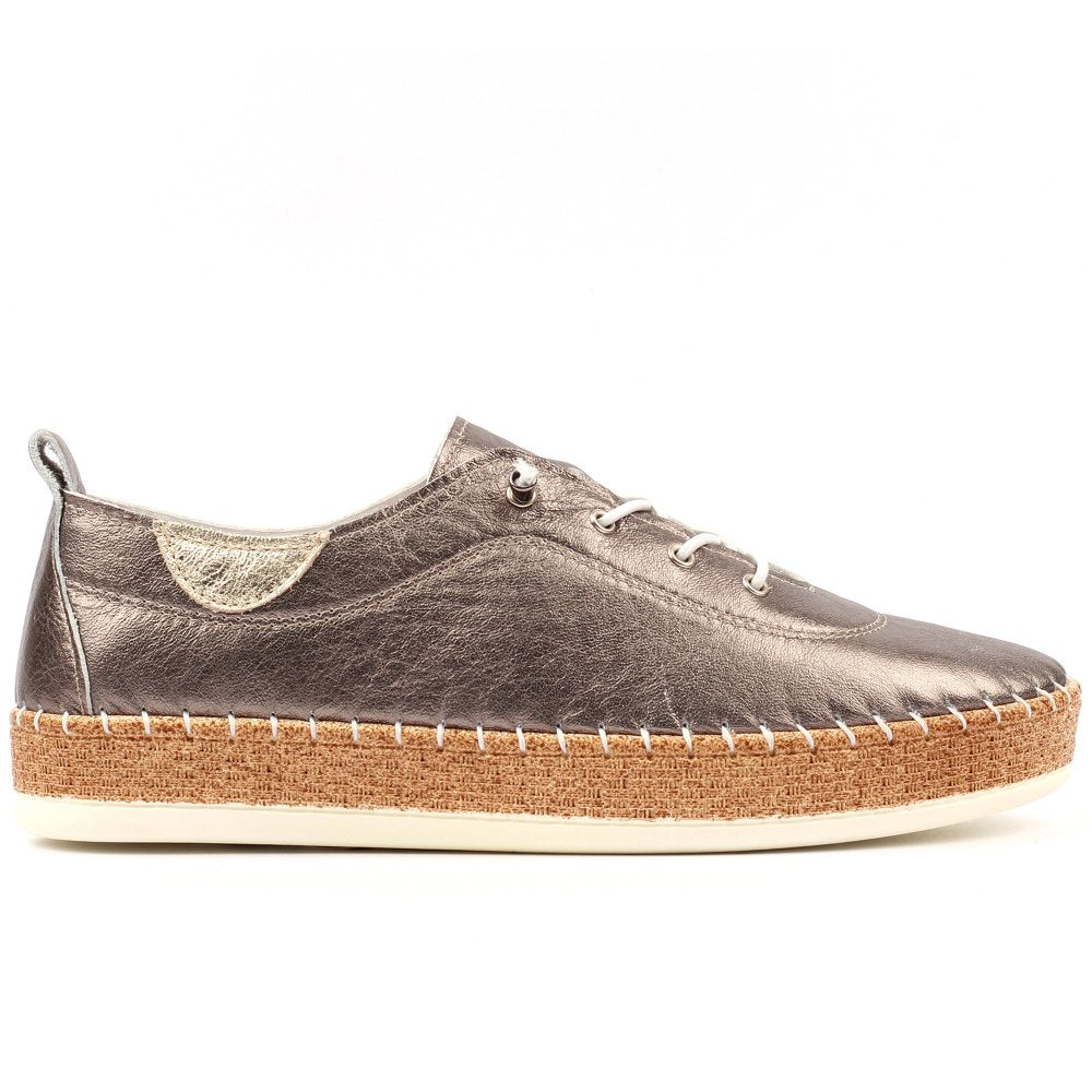 A single women's low-top espadrille shoe in distressed metallic pewter leather, featuring white laces, a cork-wrapped midsole, and a cream rubber outsole, shown from a side profile on a white background.