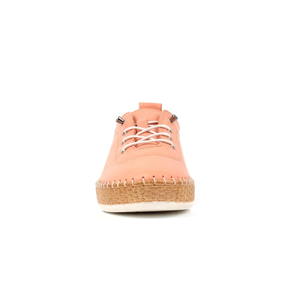 Coral espadrille shoe on a white background