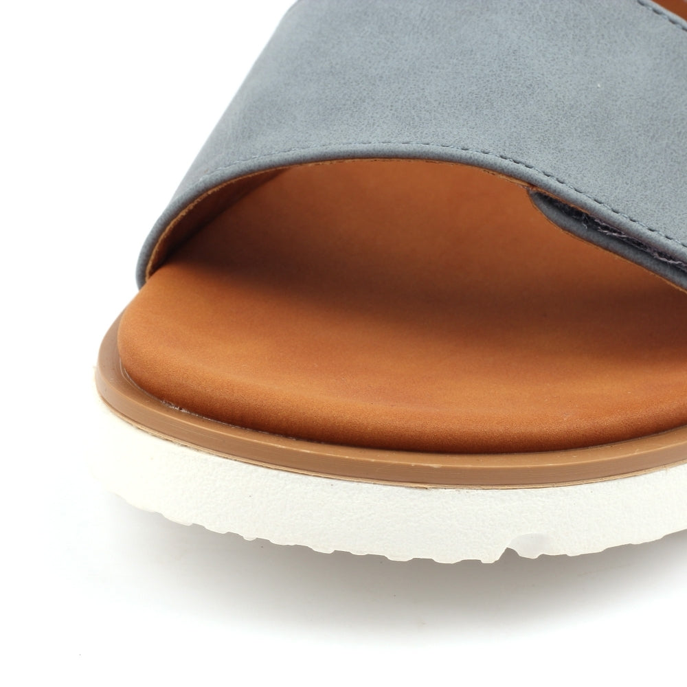 Close-up of a sandal with gray upper and brown sole on a white background