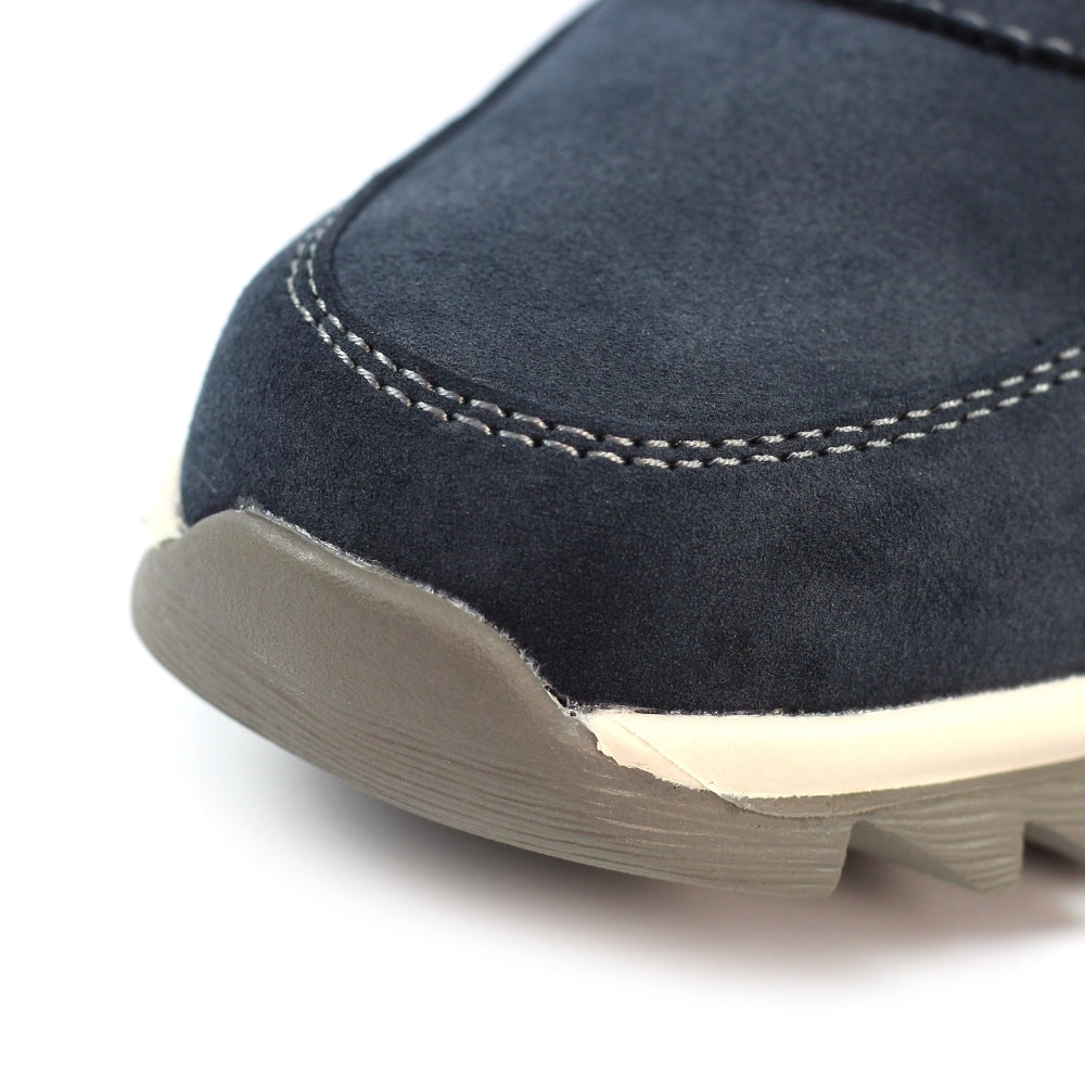 Close-up of a navy blue shoe with beige sole on a white background