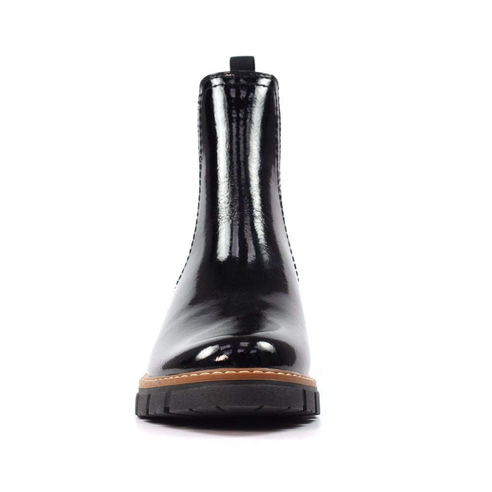 Black glossy boot with a brown sole on a white background