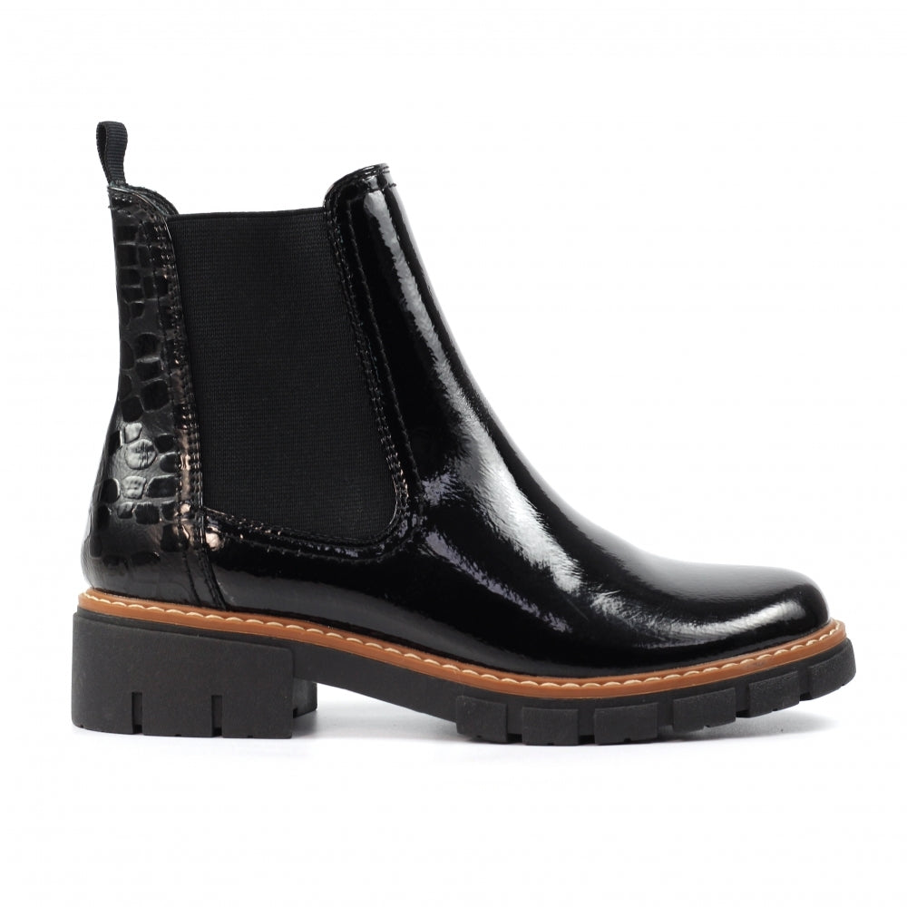 Black patent leather Chelsea boot with brown sole on a white background