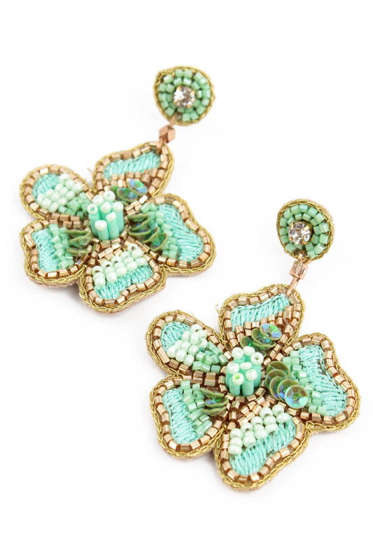 Floral earrings with turquoise and gold details on a white background
