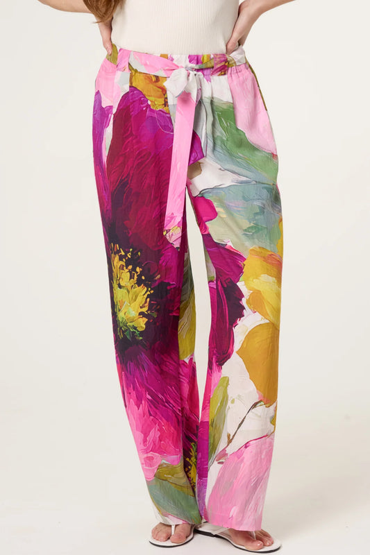 Colorful floral pants with a tie waist on a white background