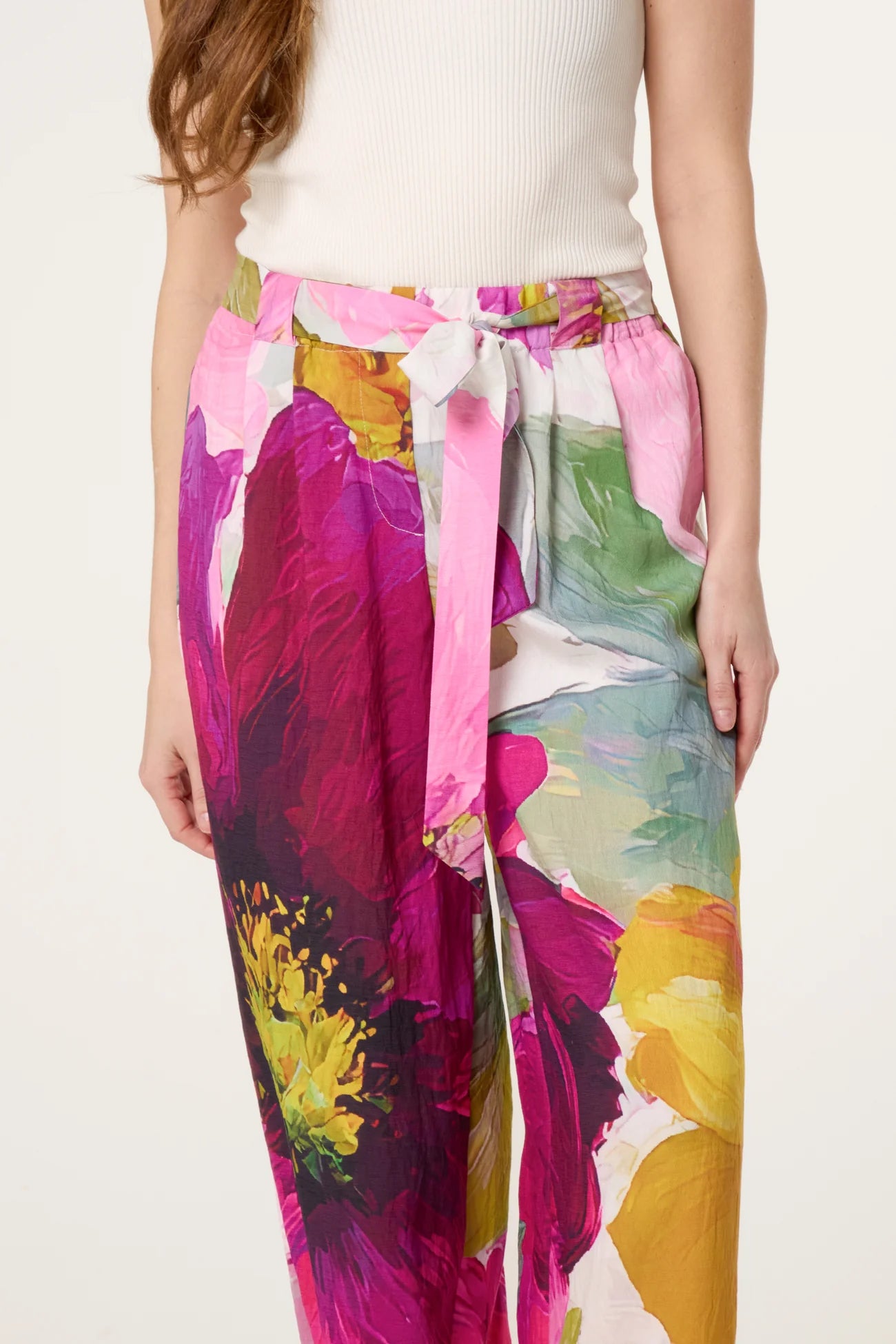 Colorful floral pants with a belt on a white background