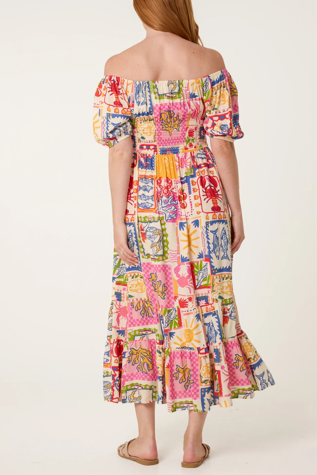 Woman wearing a colorful patchwork dress on a white background
