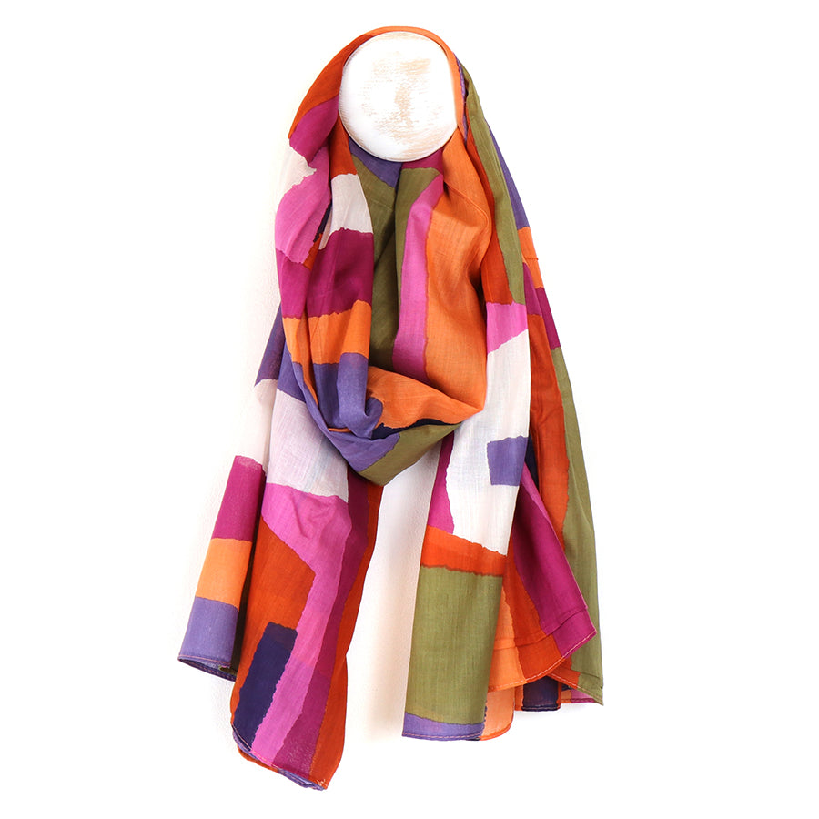 Colorful striped scarf on a mannequin head against a white background