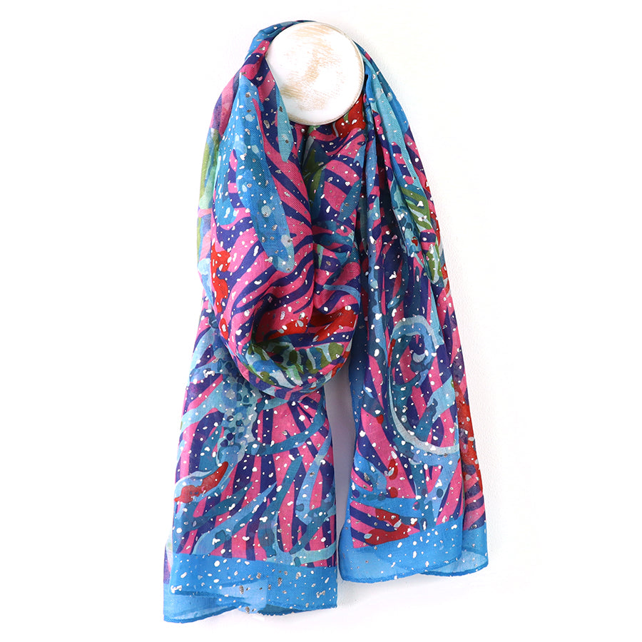 Colorful scarf with abstract pattern on a mannequin against a white background