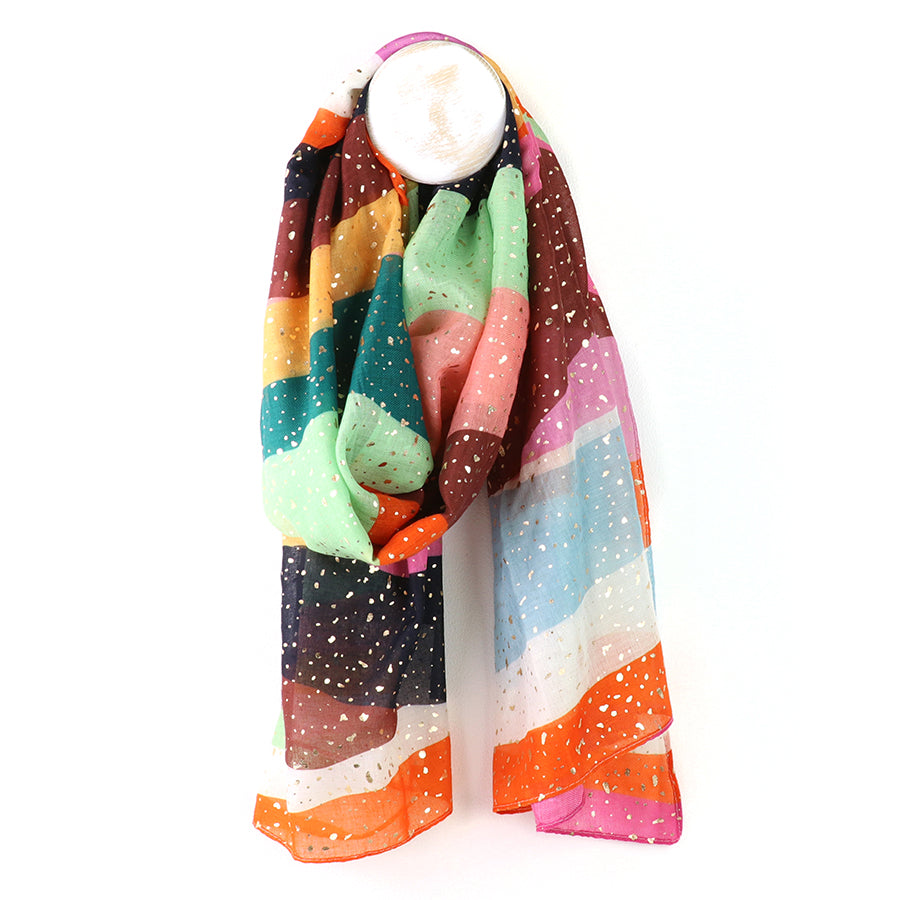 Colorful striped scarf with a white candle on a white background