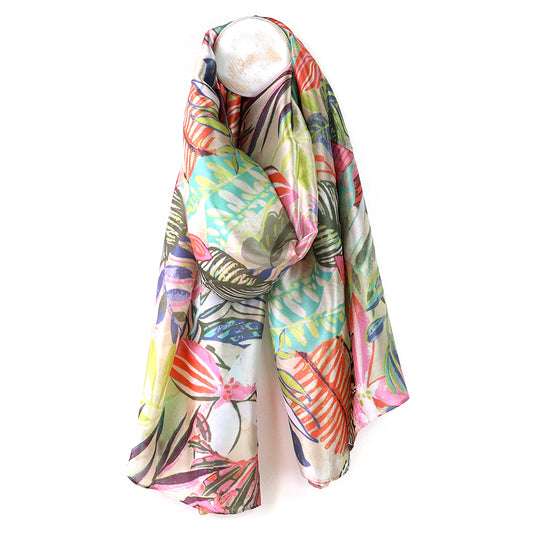 Colorful floral-patterned scarf on a mannequin against a white background