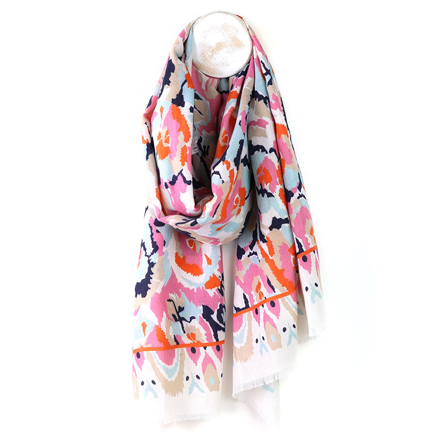 Colorful scarf with abstract pattern on a mannequin against a white background