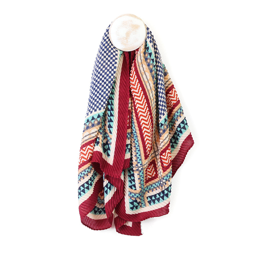 Colourful patterned square scarf draped over a mannequin on a white background