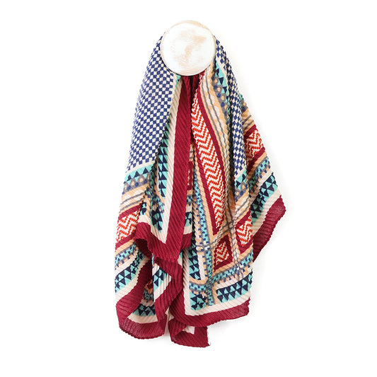 Colourful patterned square scarf draped over a mannequin on a white background