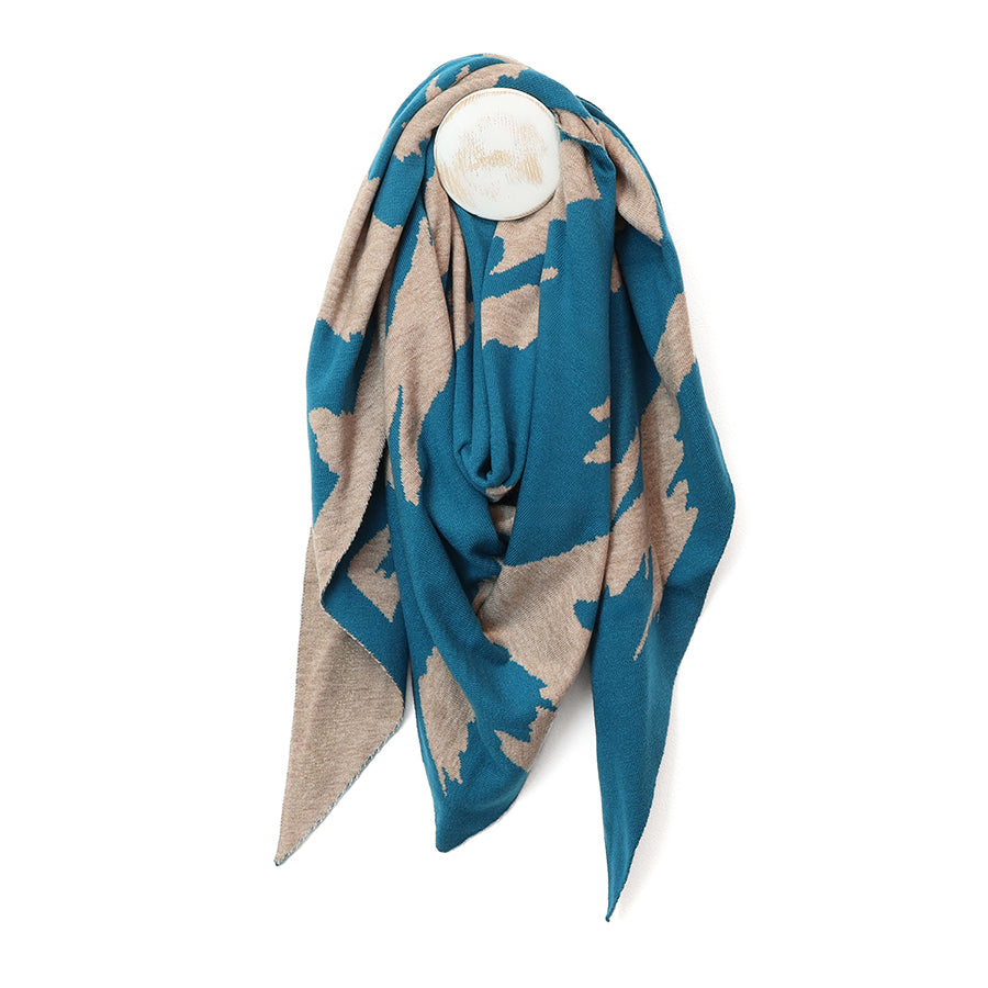 A lightweight square scarf with an abstract organic pattern in teal blue and beige, draped on a white circular mannequin against a plain white background.