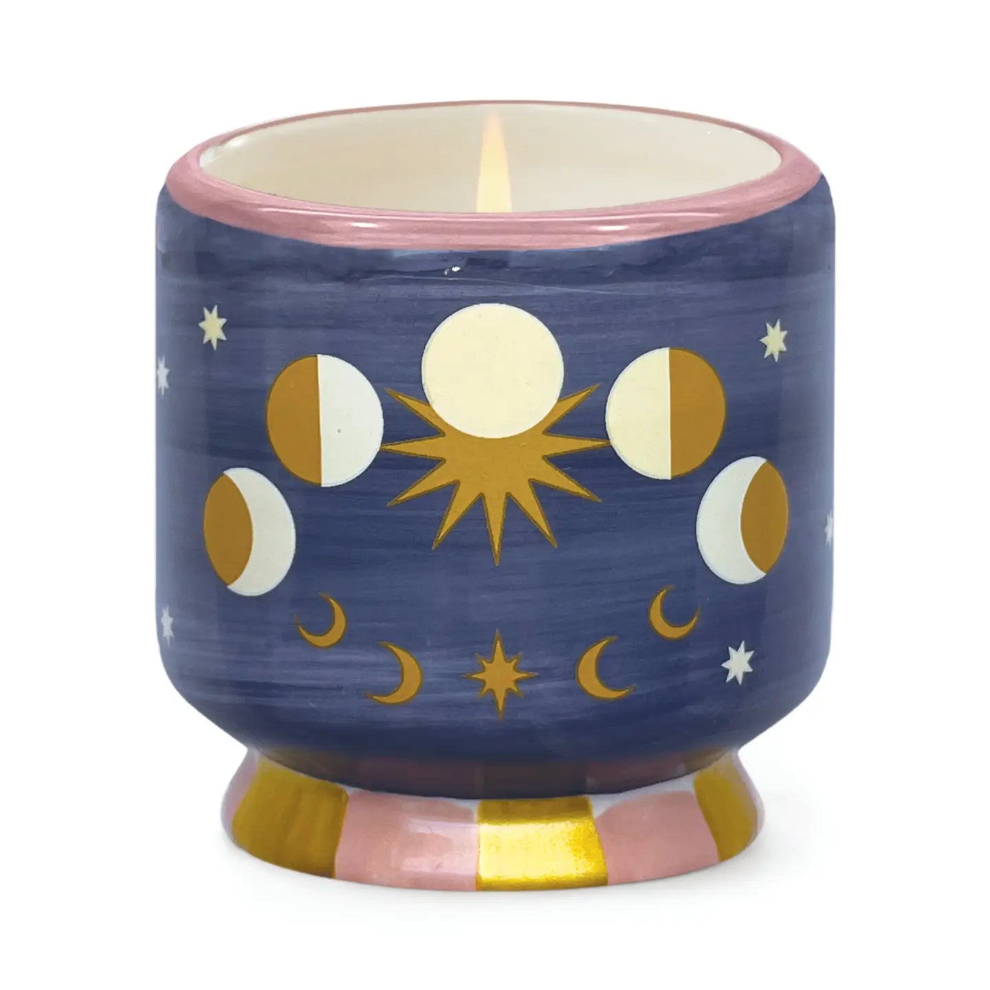 Candle in a blue ceramic holder with celestial design on a white background