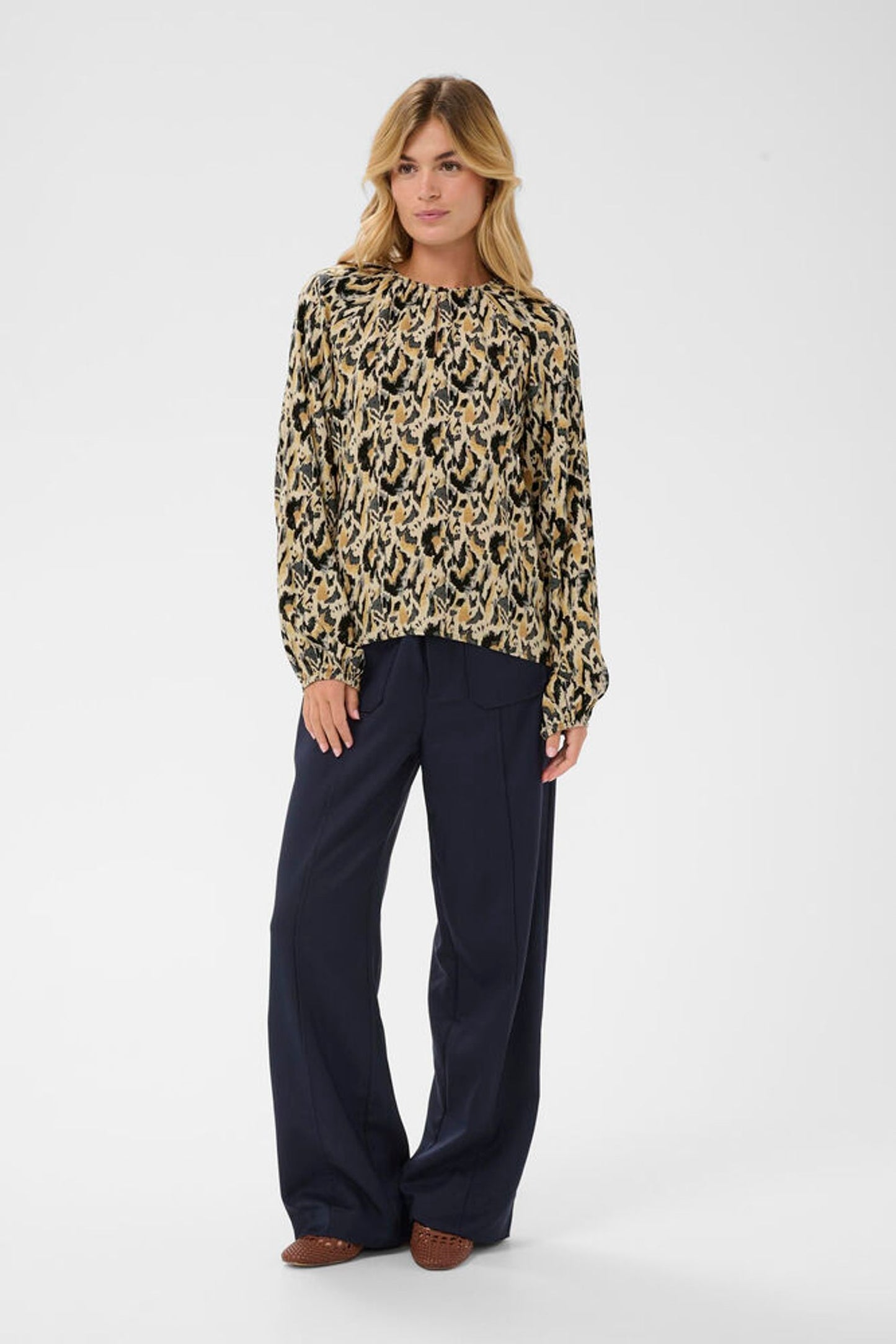 Loose fitting blouse modelled with navy trousers