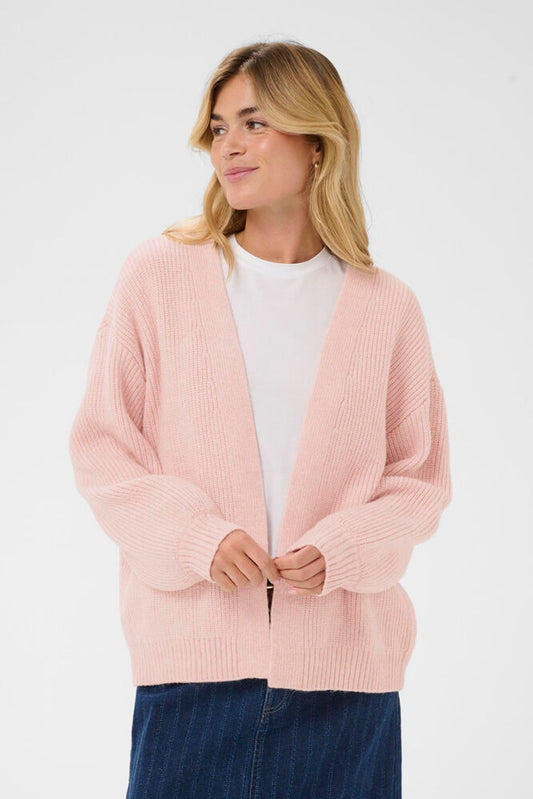 Model in a pink cardigan over a white t-shirt