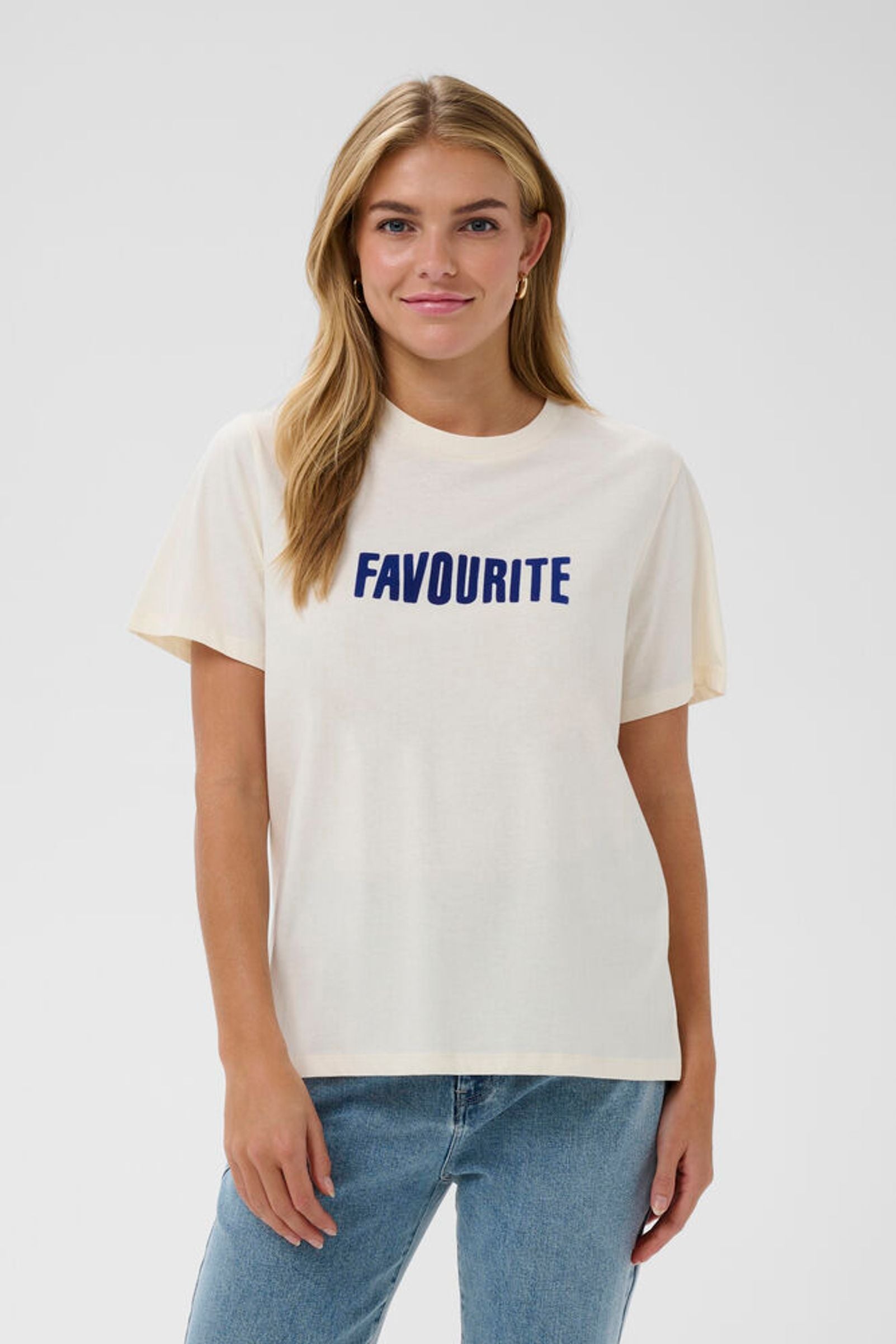 Person wearing a white t-shirt with 'FAVOURITE' printed on it against a plain background