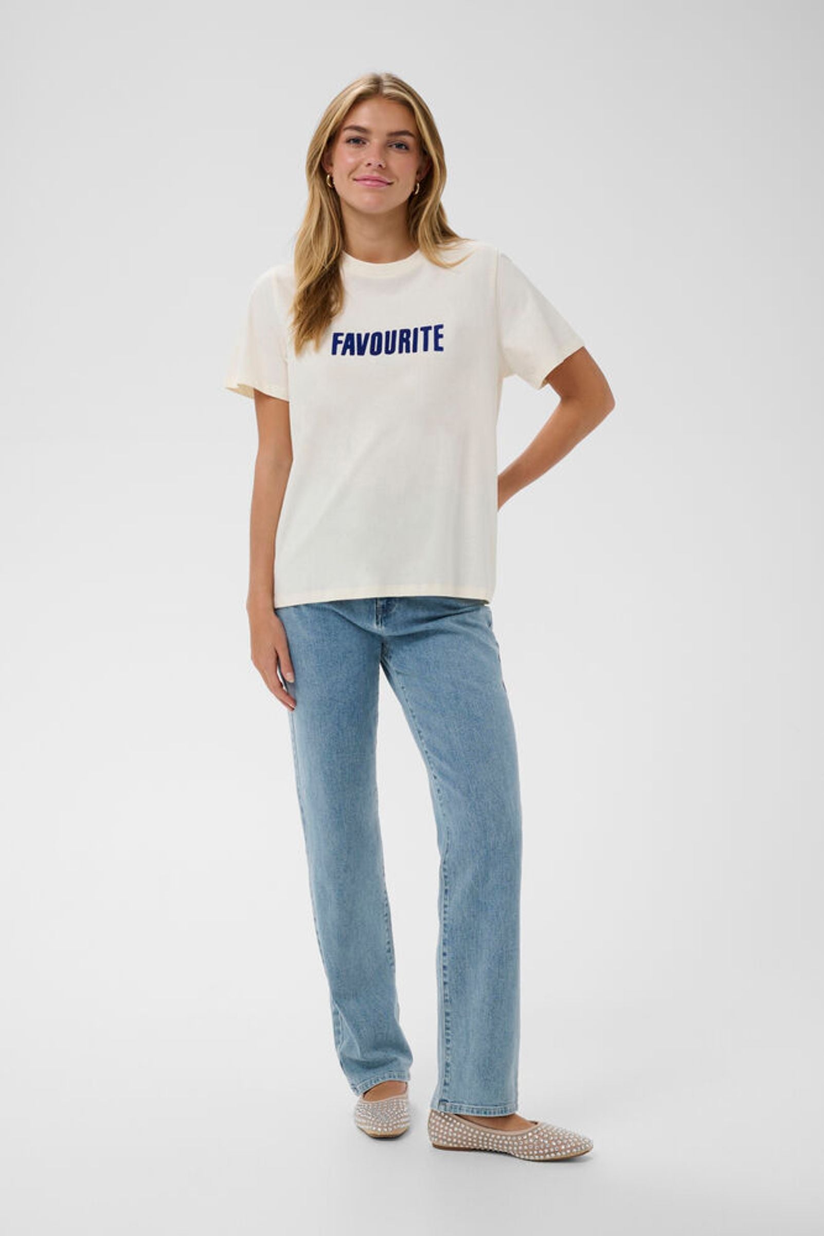  Model in jeans and white t-shirt with 'Favourite' Slogan on the front