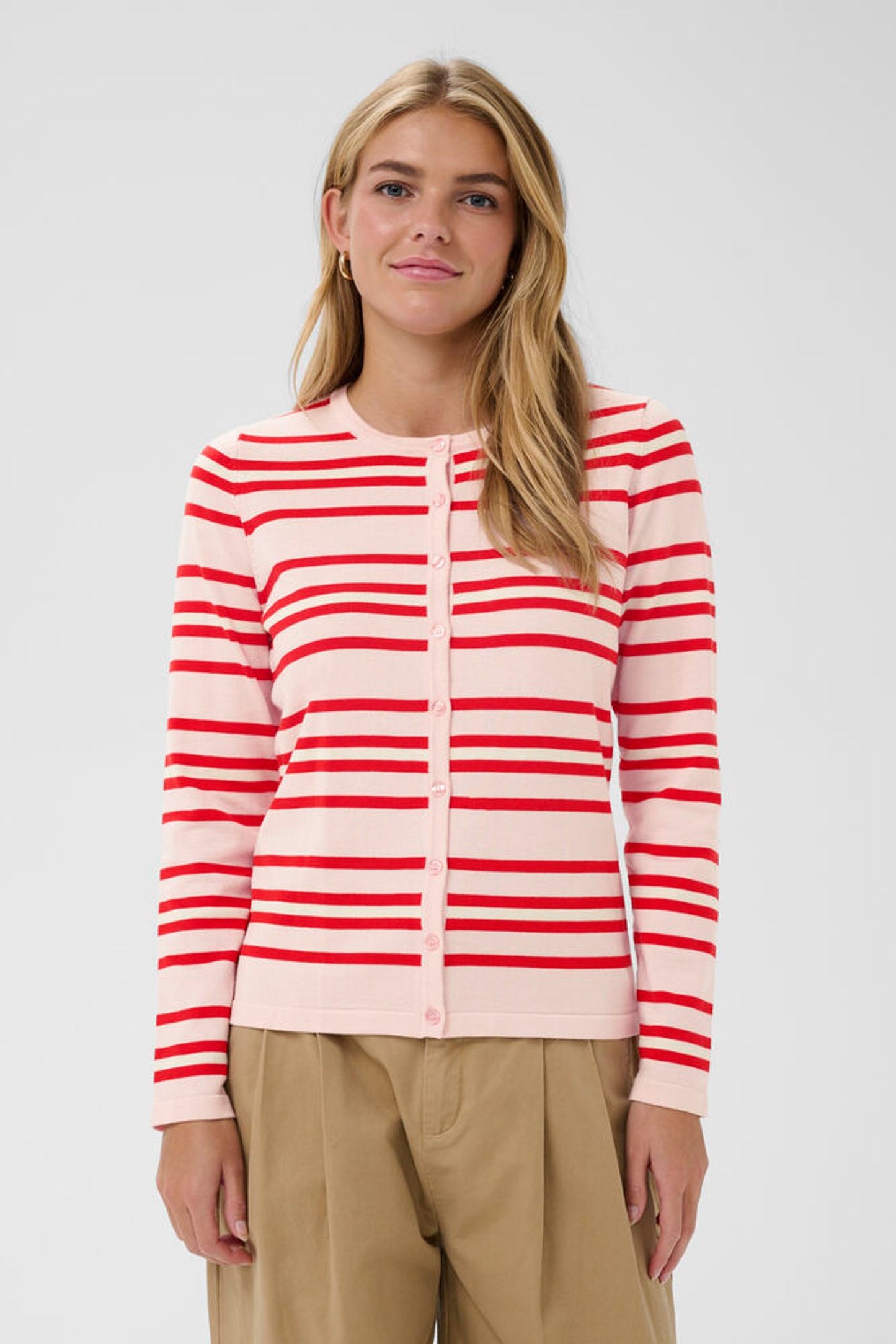 Model in pink cardigan with red stripes