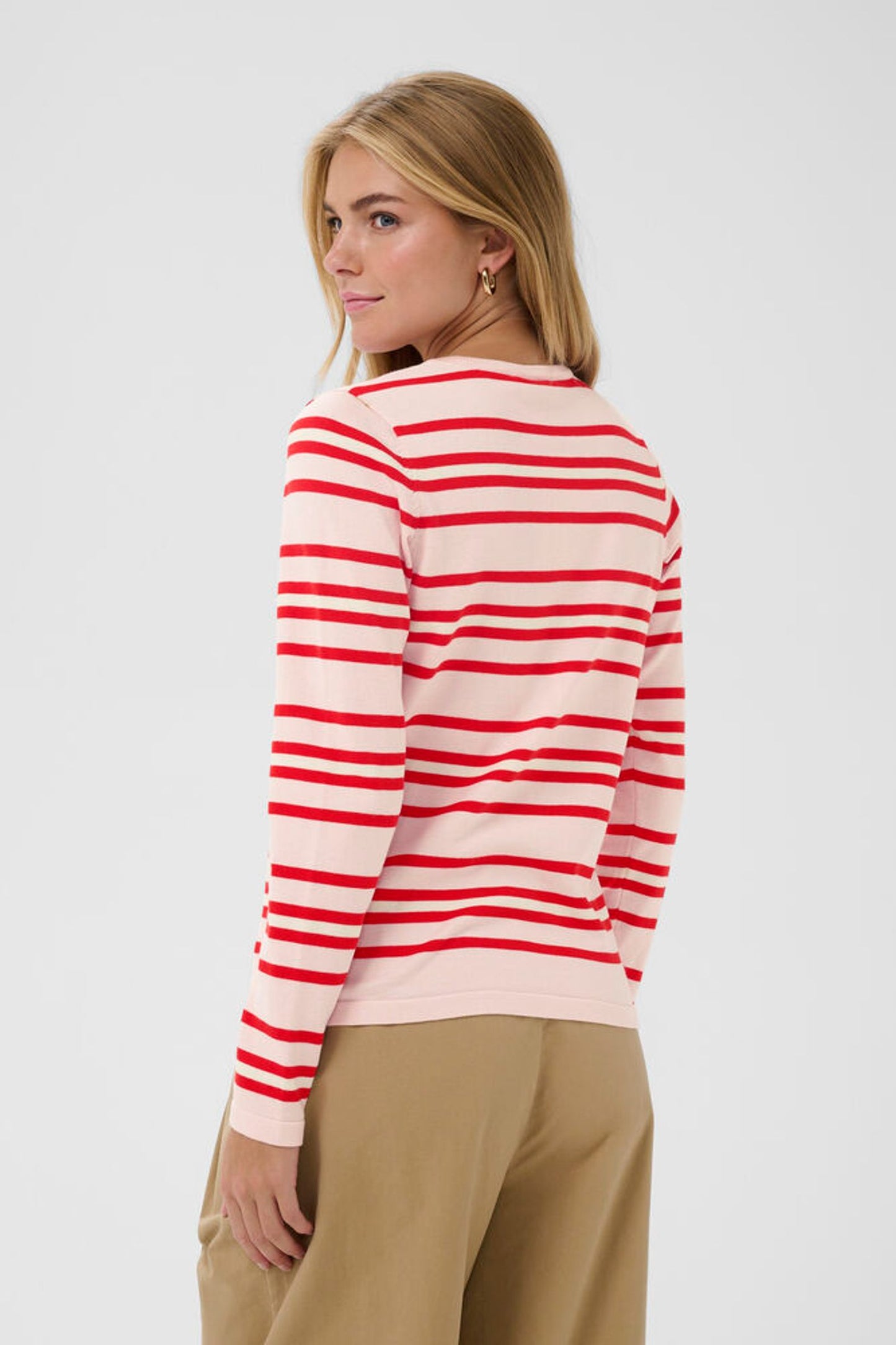 Back view of model in pink cardigan with red stripes