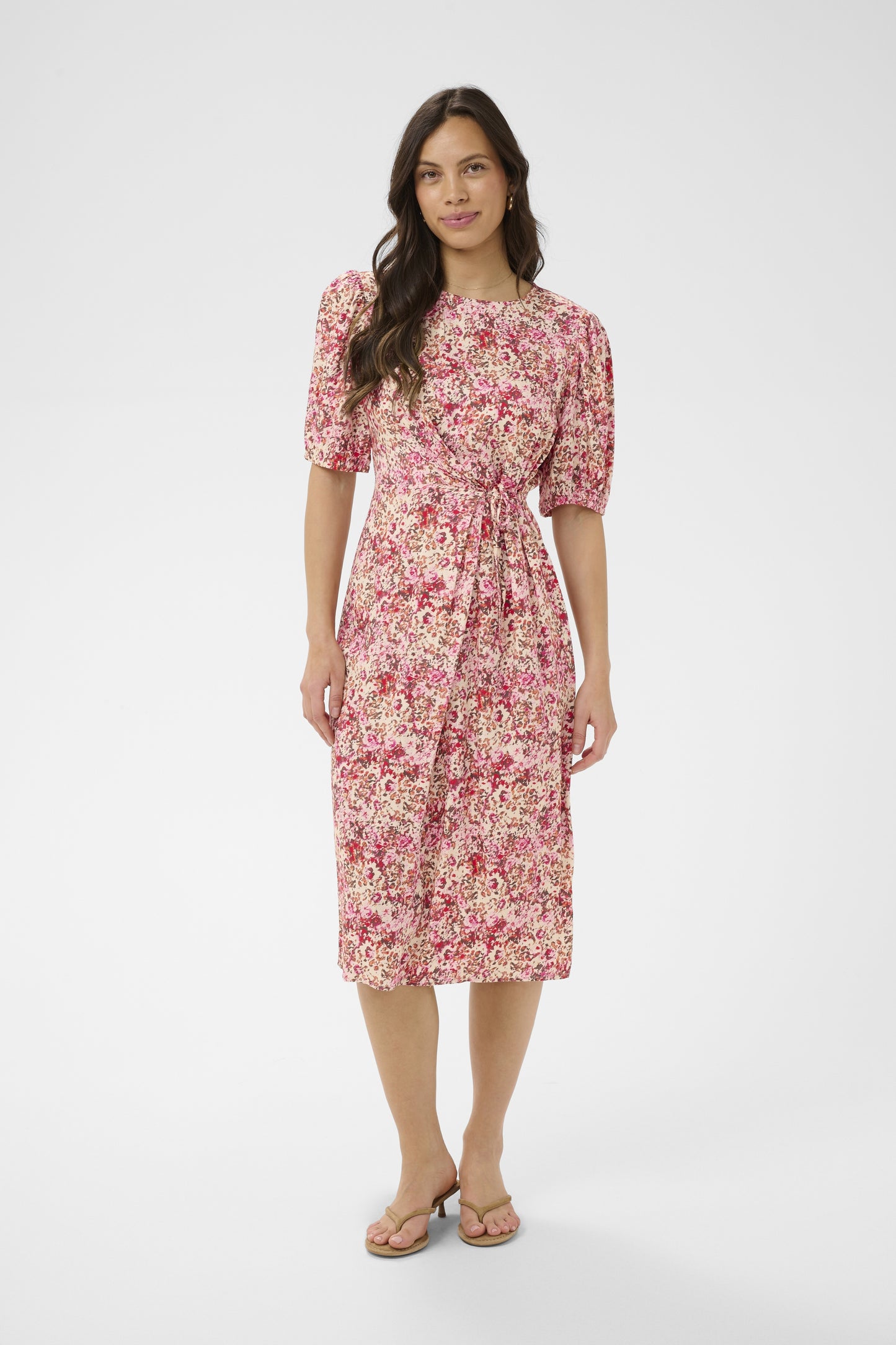 Woman wearing a floral dress on a white background