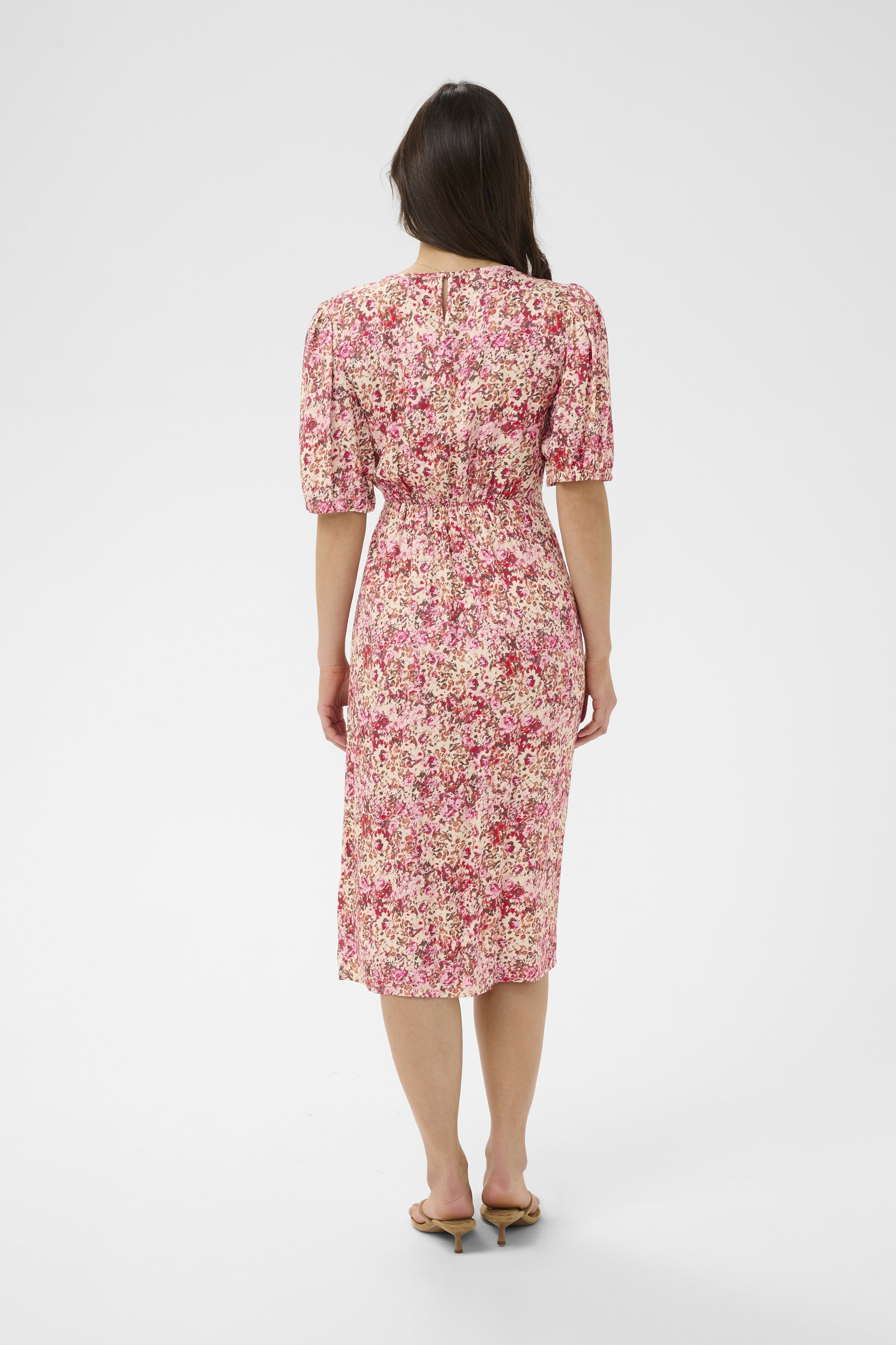 Woman wearing a floral dress on a white background