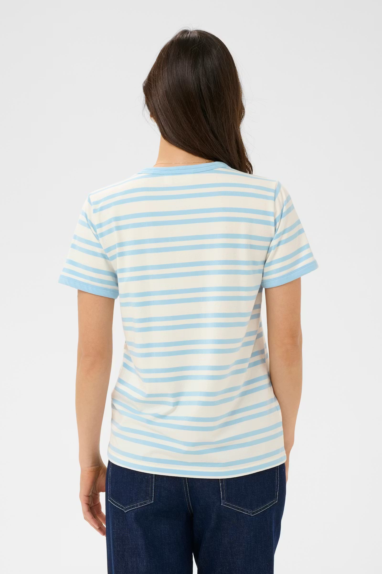 Person wearing a striped shirt with blue and white horizontal lines on a plain background