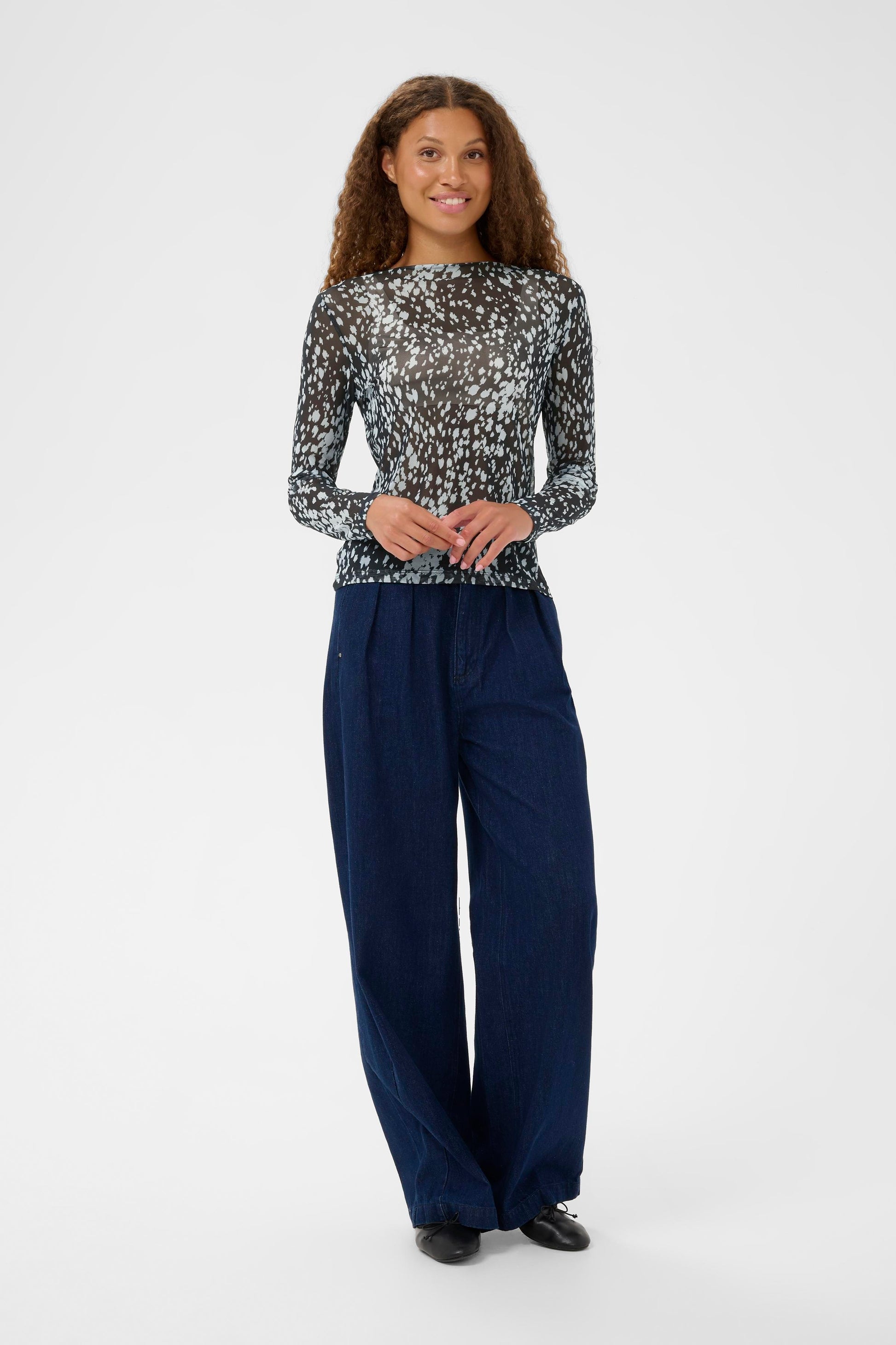 Model in sheer top with jeans