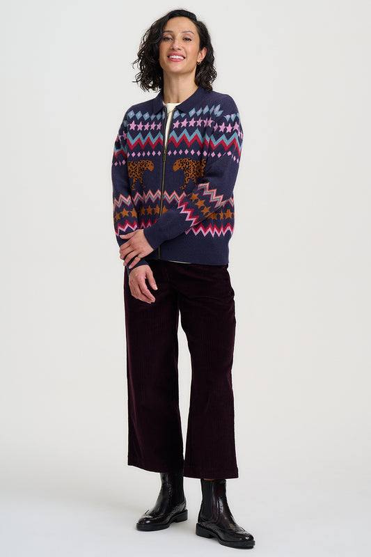 Person wearing a patterned sweater with a white background