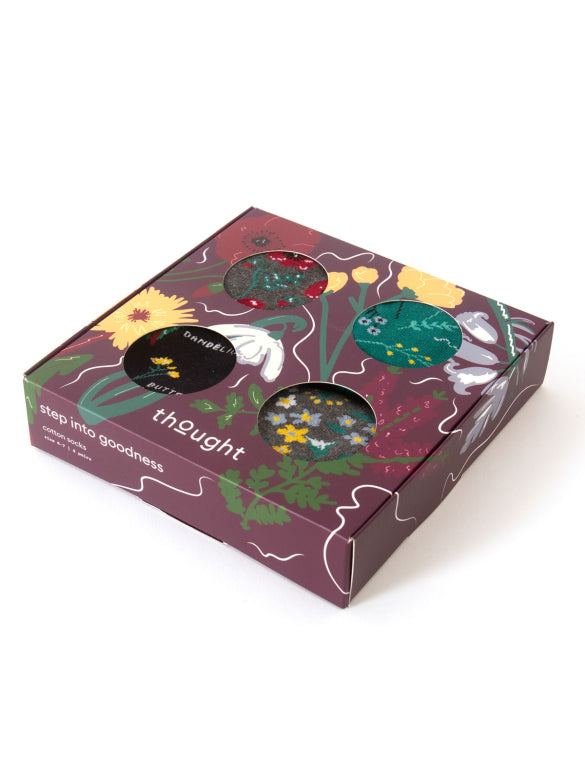 Packaged socks with floral design and 'thOught' branding on a white background