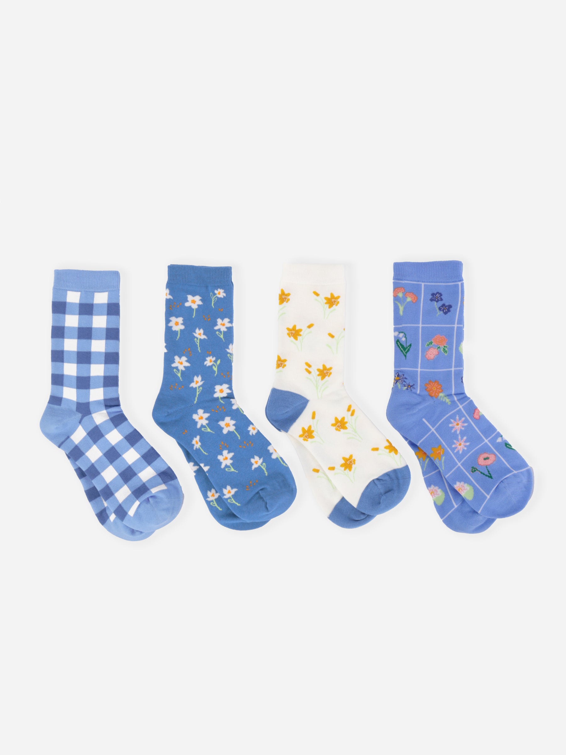 Four pairs of socks with different patterns on a white background