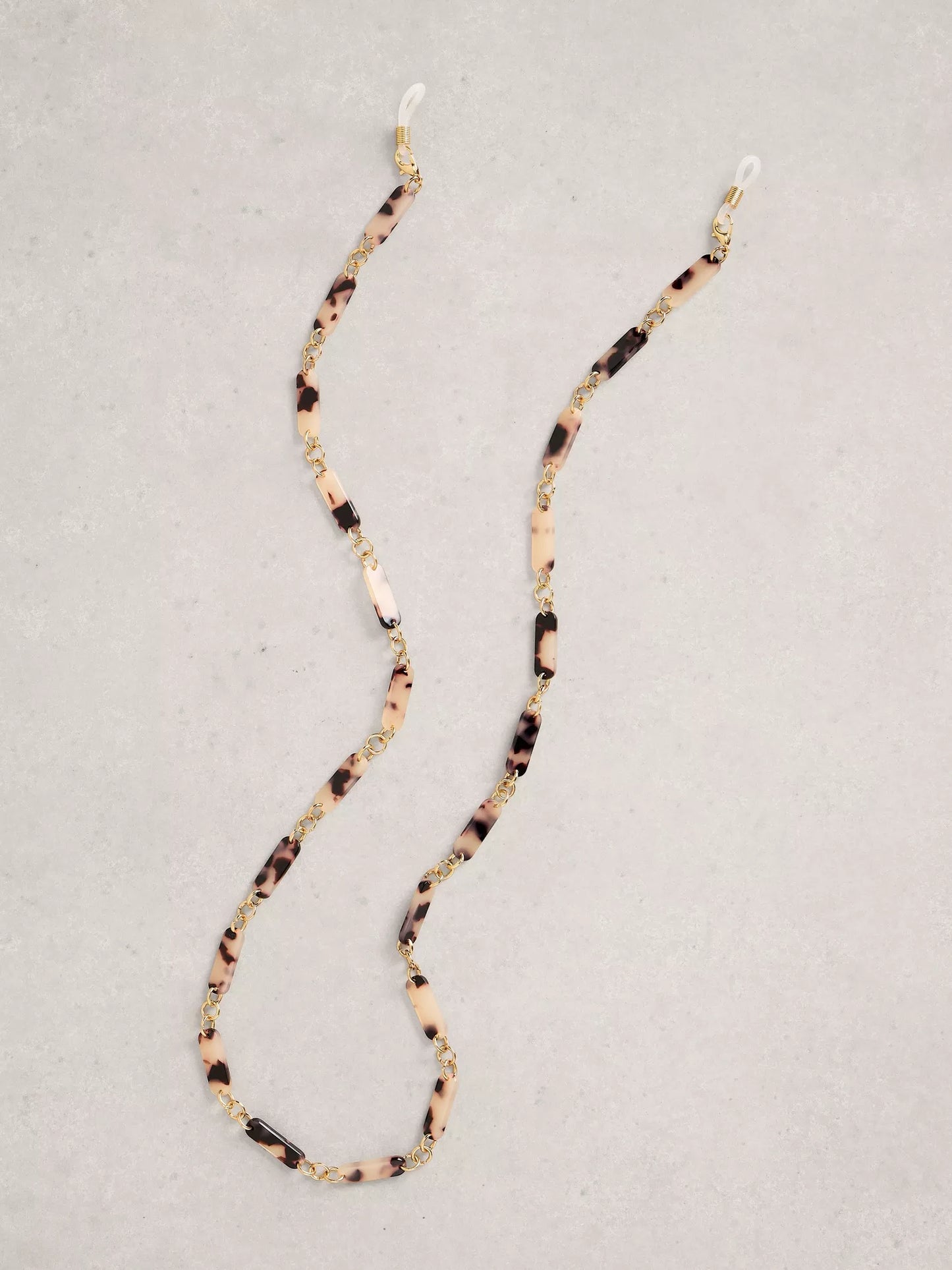 Beaded eyeglass strap with tortoiseshell pattern on a light gray background
