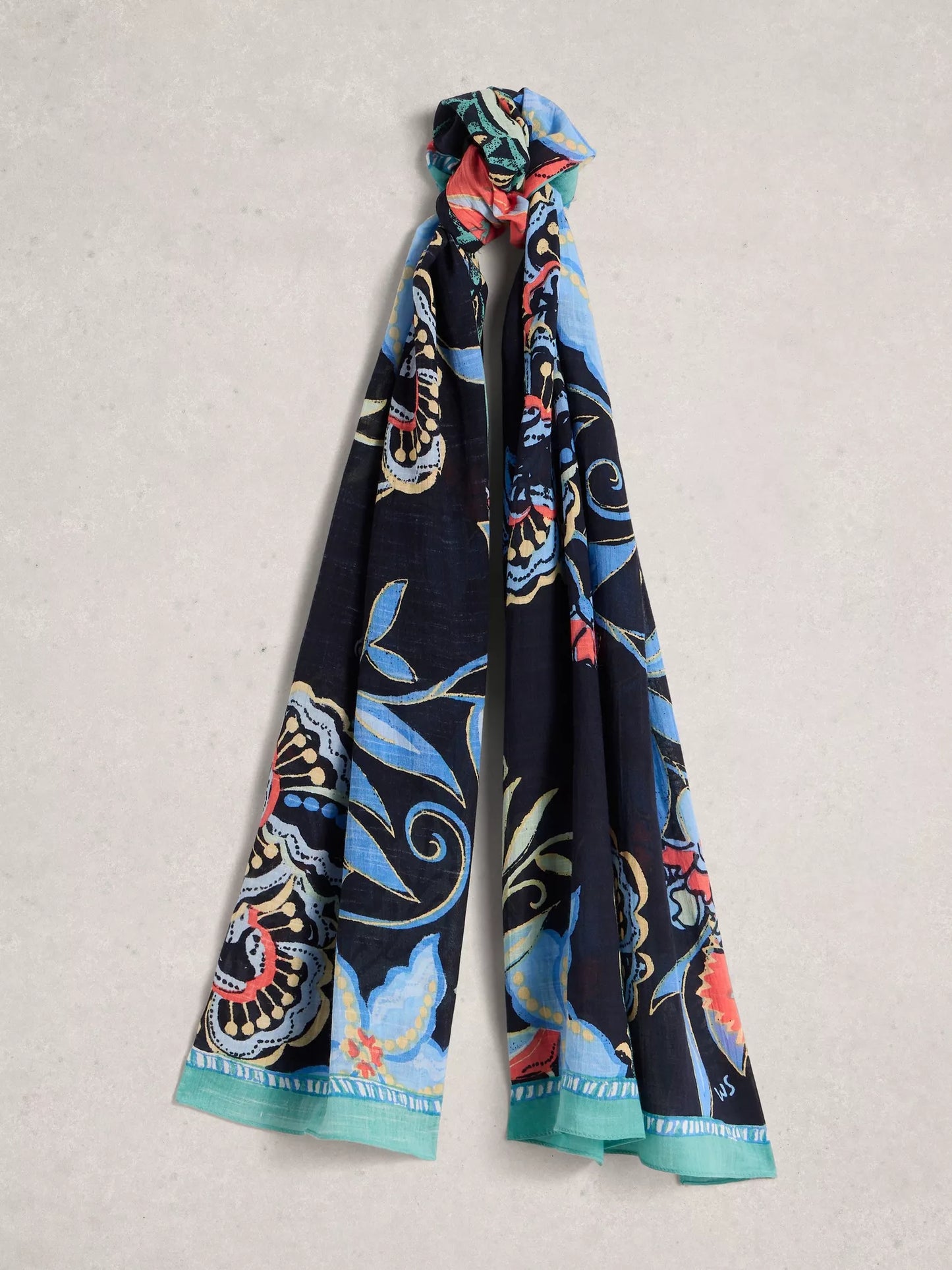 Colorful patterned scarf on a light gray background