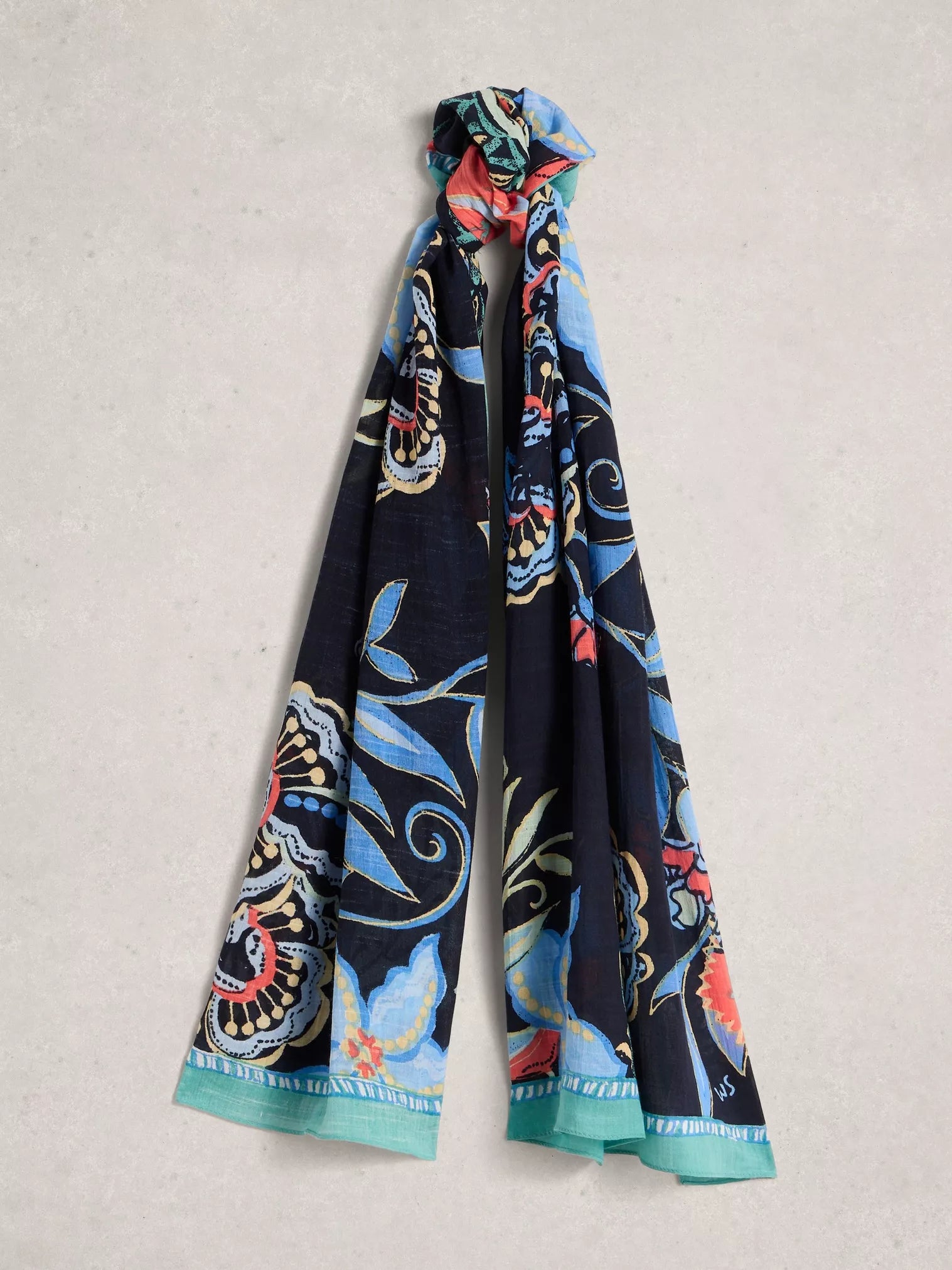 Colorful patterned scarf on a light gray background