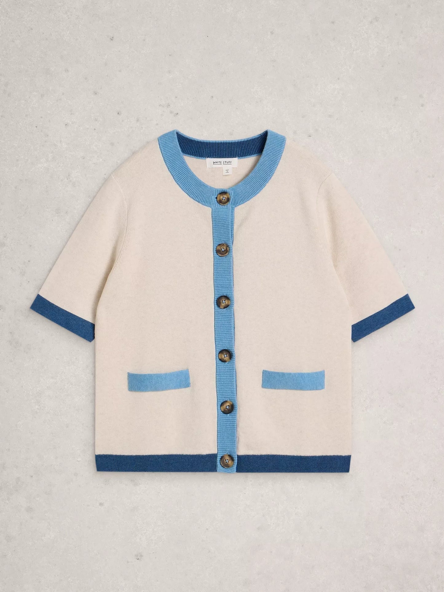 Beige cardigan with blue accents on a light gray background