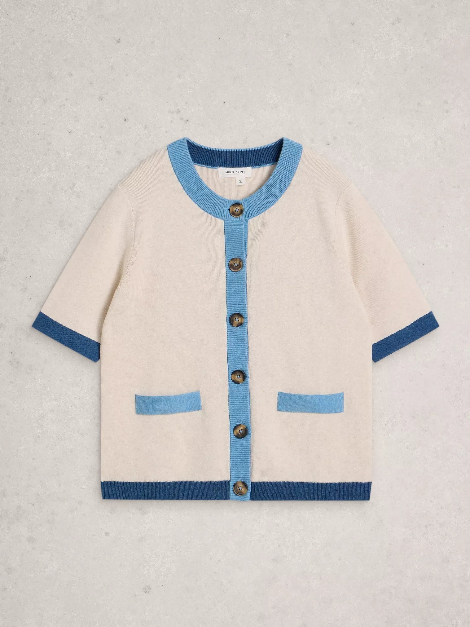 Beige cardigan with blue accents on a light gray background