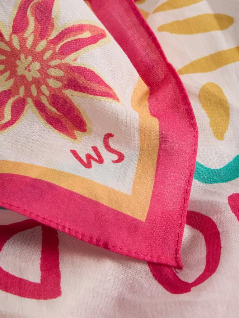 Close-up of a colorful fabric with floral patterns and initials 'WS'.